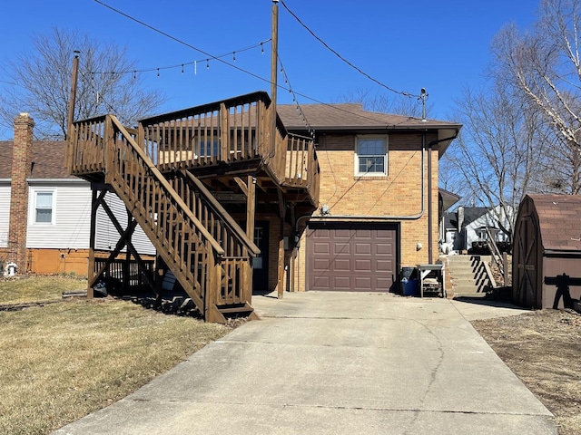 view of front of house with an attached garage, brick siding, stairs, driveway, and a wooden deck