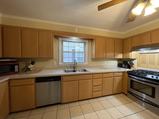 kitchen featuring stainless steel appliances, light countertops, light brown cabinets, a sink, and under cabinet range hood