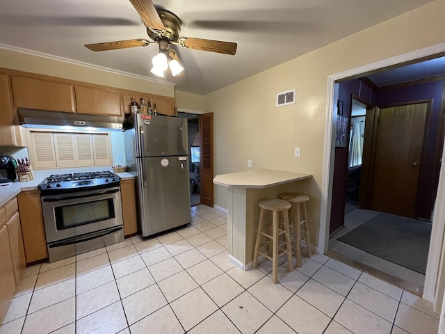 kitchen with appliances with stainless steel finishes, visible vents, under cabinet range hood, and light tile patterned flooring