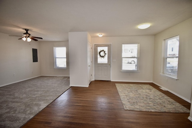 entryway with electric panel, baseboards, dark wood-type flooring, and ceiling fan