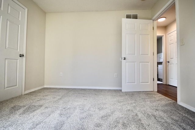 unfurnished bedroom with baseboards, visible vents, and carpet floors