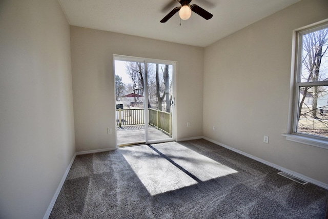 spare room with visible vents, ceiling fan, baseboards, and carpet floors