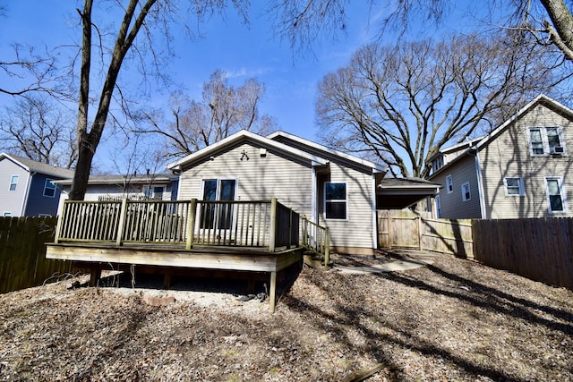 back of property featuring a deck and a fenced backyard