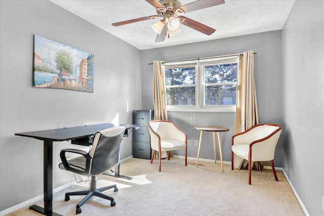 carpeted home office with ceiling fan, baseboards, and a textured ceiling