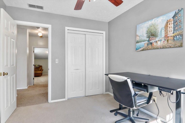 office area featuring baseboards, carpet, visible vents, and a textured ceiling