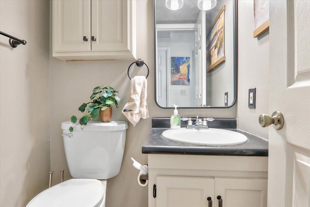 bathroom with toilet and vanity