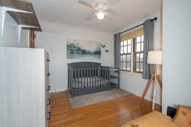 bedroom with baseboards and wood finished floors