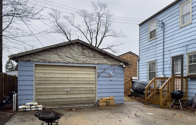 detached garage featuring fence