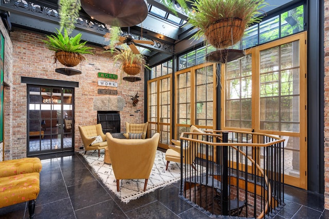 sunroom / solarium with a healthy amount of sunlight, a skylight, and a fireplace