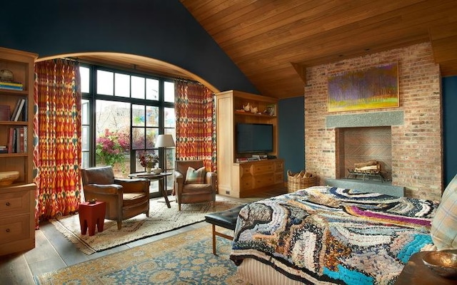 bedroom featuring wooden ceiling, a brick fireplace, vaulted ceiling, and wood finished floors