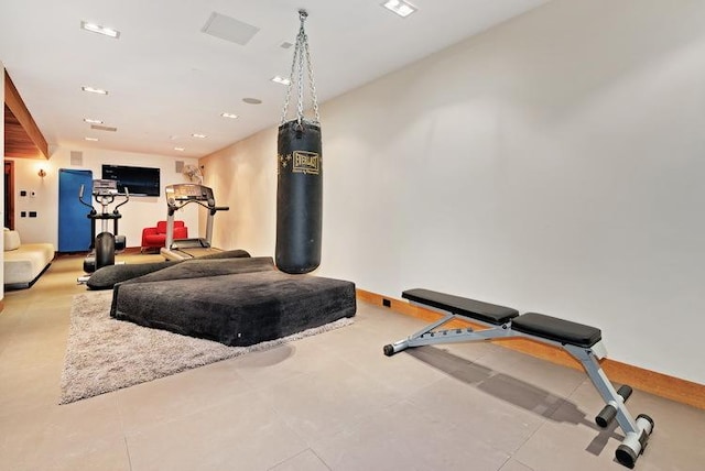 exercise room featuring baseboards and recessed lighting