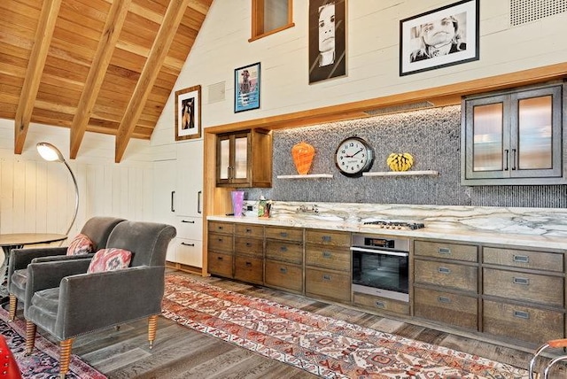 kitchen featuring lofted ceiling with beams, wood ceiling, stainless steel oven, decorative backsplash, and brown cabinets