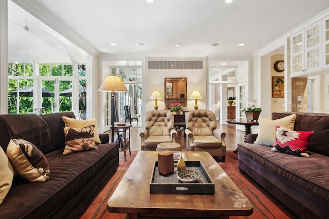 living room featuring visible vents, recessed lighting, ornamental molding, and wood finished floors