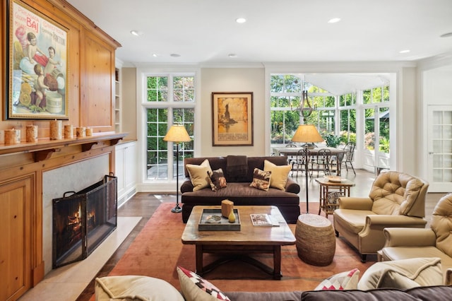 living room with ornamental molding, plenty of natural light, and a premium fireplace