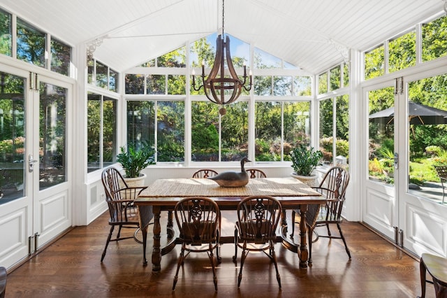 sunroom featuring a chandelier and vaulted ceiling