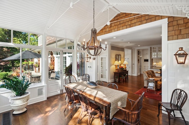 dining room featuring lofted ceiling with beams, visible vents, a notable chandelier, and dark wood-style flooring