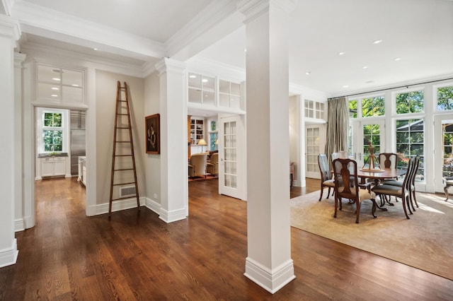 dining room featuring french doors, crown molding, dark wood-style flooring, and ornate columns