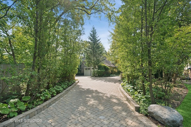 view of front facade featuring decorative driveway and fence