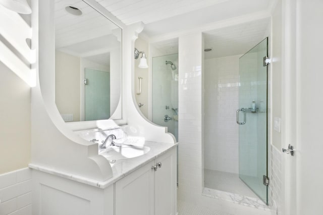 bathroom with a stall shower and vanity