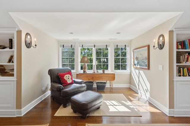 living area featuring baseboards and wood finished floors