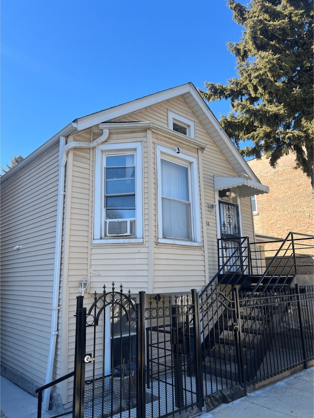 view of front facade featuring stairs and fence