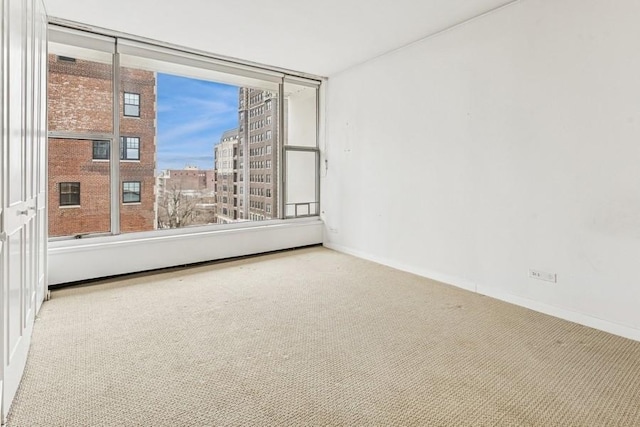 unfurnished room featuring baseboards and carpet floors