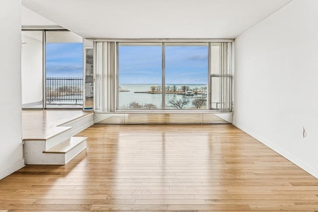 empty room featuring baseboards and wood finished floors