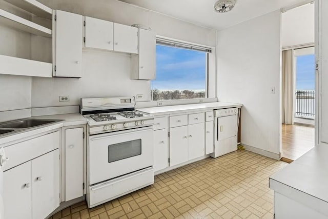 kitchen with open shelves, white appliances, white cabinets, and light countertops