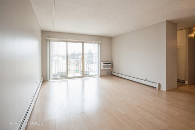 empty room with a baseboard heating unit, an AC wall unit, light wood finished floors, and a baseboard radiator