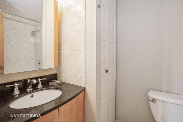 full bathroom with vanity and toilet