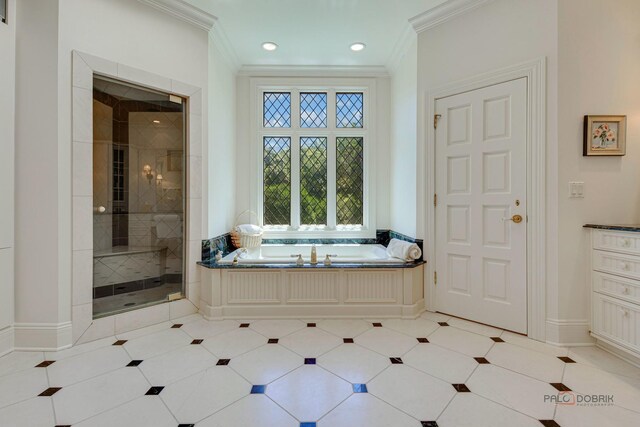 bathroom with baseboards, tiled shower, a garden tub, and crown molding