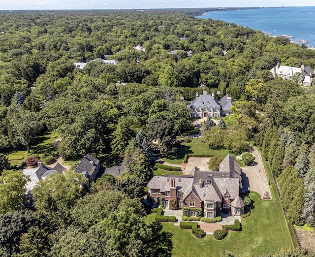 bird's eye view with a water view and a forest view