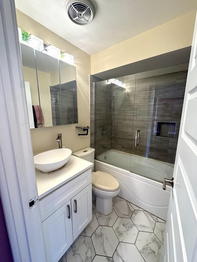 bathroom featuring enclosed tub / shower combo, toilet, vanity, visible vents, and marble finish floor