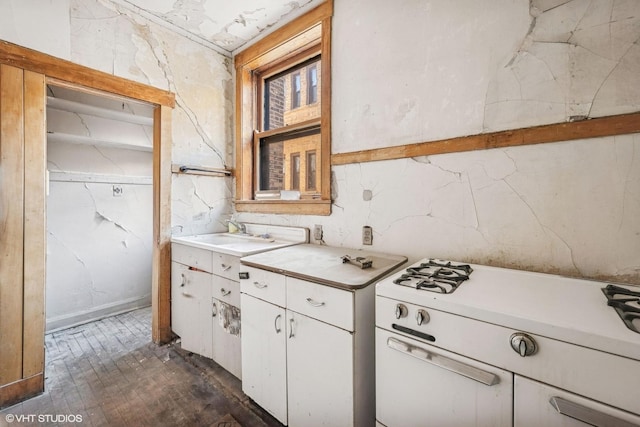 kitchen featuring a sink, white cabinets, and light countertops