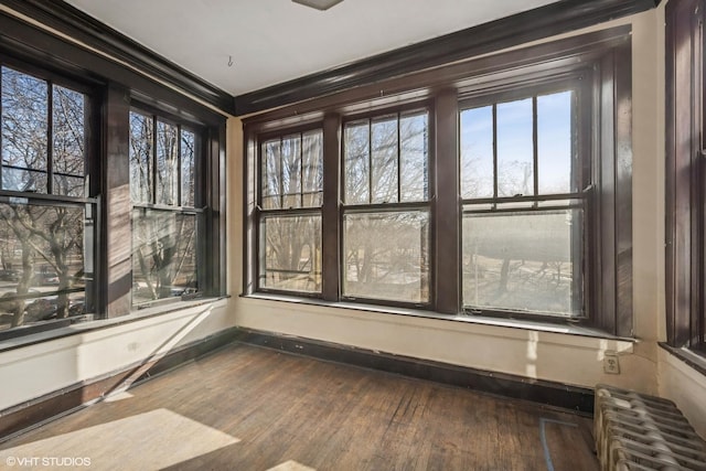 unfurnished sunroom featuring radiator