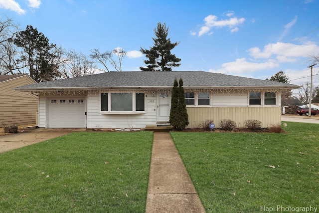 ranch-style house featuring a front yard, concrete driveway, roof with shingles, and an attached garage