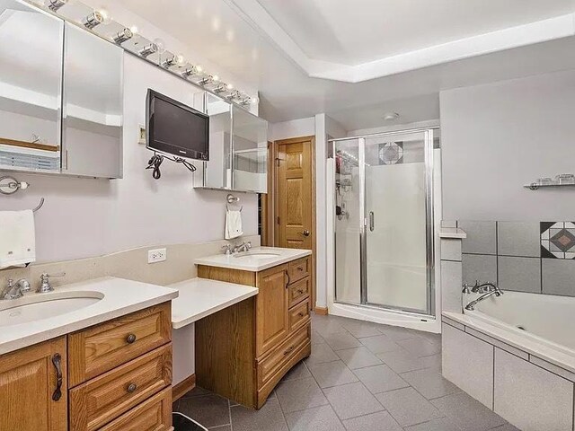 22915 Mcguire Rd, Wilmington, IL 60481 - bathroom with tile patterned floors, a stall shower, vanity, and a bath