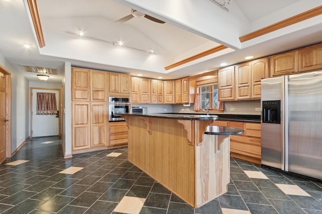 22915 Mcguire Rd, Wilmington, IL 60481 - kitchen with visible vents, a tray ceiling, lofted ceiling, stainless steel appliances, and a kitchen breakfast bar