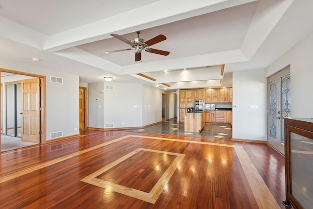 22915 Mcguire Rd, Wilmington, IL 60481 - unfurnished living room with a tray ceiling, hardwood / wood-style flooring, and visible vents