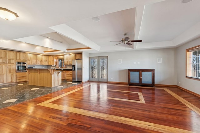 22915 Mcguire Rd, Wilmington, IL 60481 - unfurnished living room featuring a tray ceiling, baseboards, dark wood-type flooring, and ceiling fan