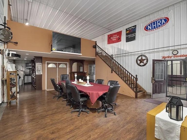 22915 Mcguire Rd, Wilmington, IL 60481 - dining area with stairway, a high ceiling, metal wall, and wood finished floors