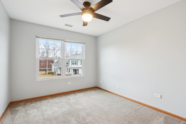 empty room featuring visible vents, baseboards, ceiling fan, and carpet flooring