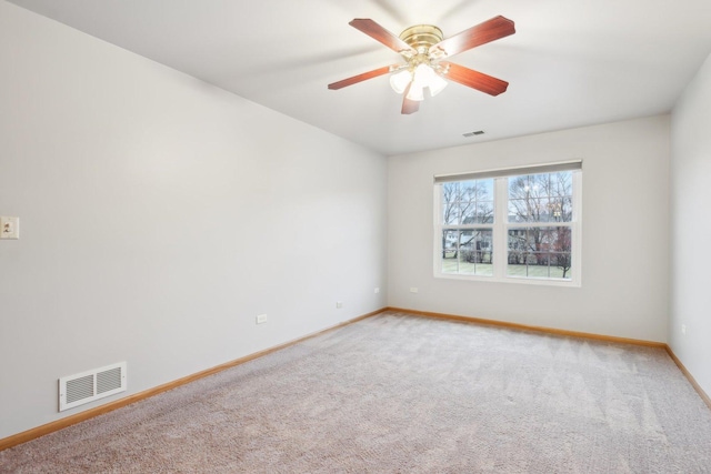 unfurnished room with light carpet, visible vents, ceiling fan, and baseboards