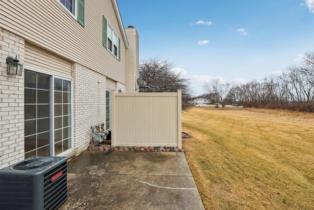 view of yard with a patio area and central air condition unit