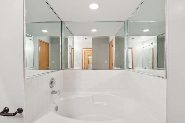 full bath with recessed lighting and a bath