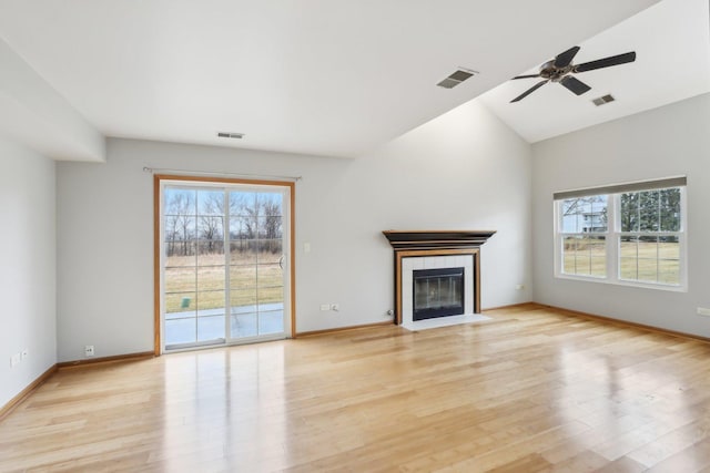 unfurnished living room with visible vents, light wood-style floors, and a tile fireplace