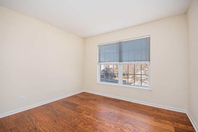 unfurnished room featuring dark wood finished floors and baseboards