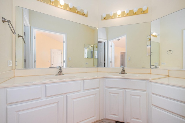 full bathroom featuring double vanity and a sink