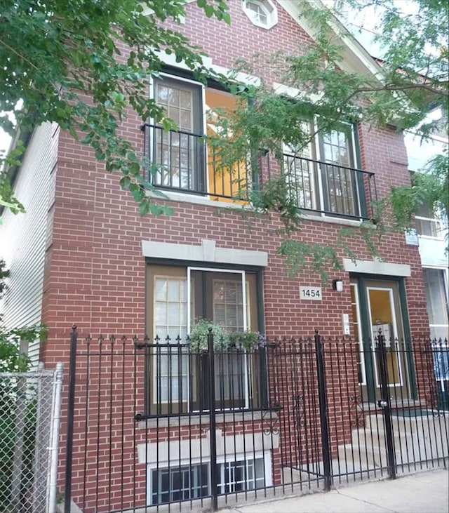 view of front facade featuring a fenced front yard and brick siding