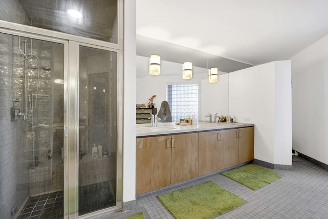 full bath featuring double vanity, lofted ceiling, tile patterned flooring, a shower stall, and a sink